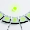 Seven translucent glass platform tiles arranged in a curved arc, each subtly engraved with a different industry icon (currency symbol, briefcase, handshake, resume, logistics arrow, database grid, notebook), all converging toward a central glowing lime green node