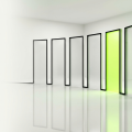 Eight tall translucent glass doorways arranged in a gentle curved row on a clean reflective white floor, seven of them clear and softly frosted, one glowing with lime green